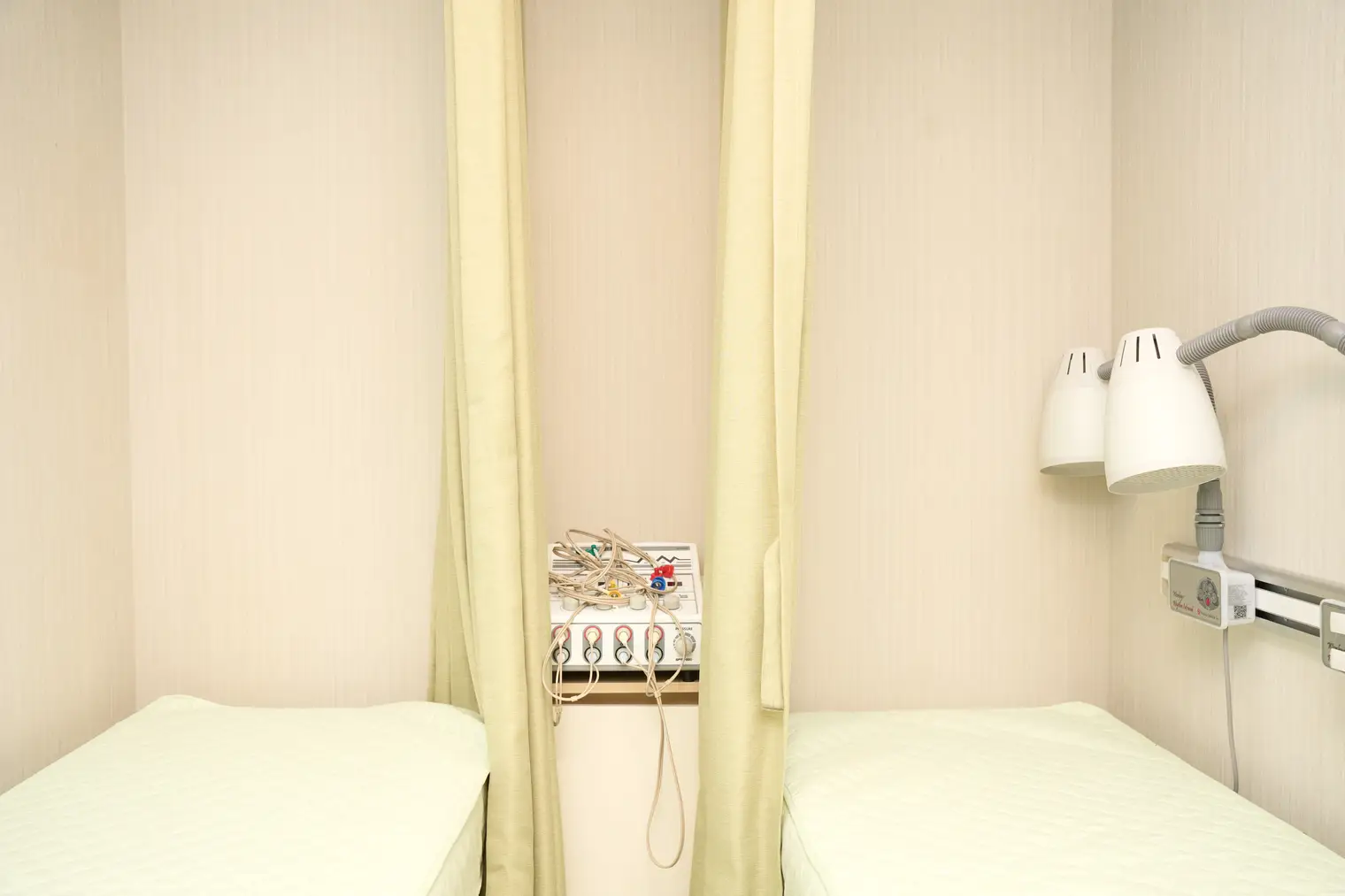 Treatment beds at NuA Korean Medicine Clinic separated by curtains