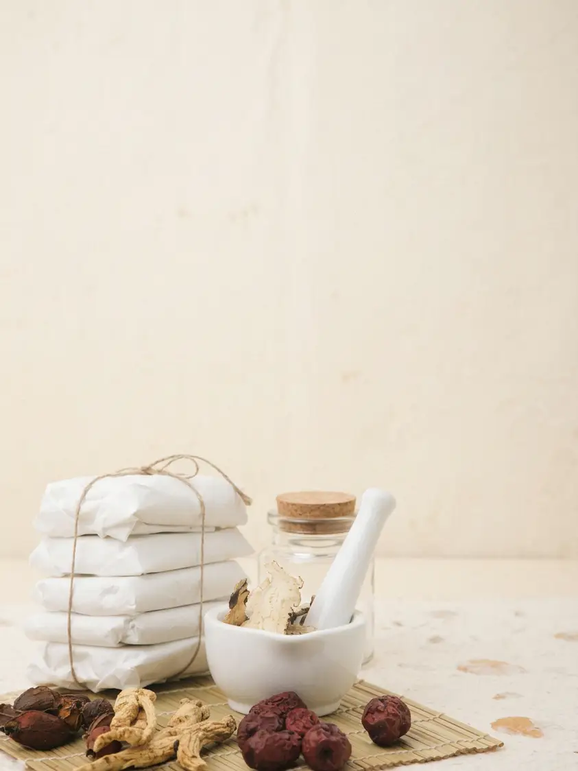 A still life of a mortar, dried jujubes and herbs, and a glass jar