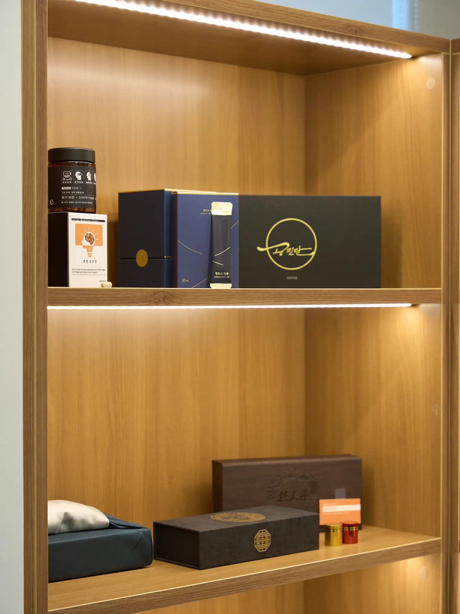 Herbal medicine product boxes on a display shelf at NuA Korean Medicine Clinic